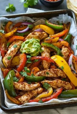Colorful Whole30 Sheet Pan Fajitas with bell peppers and chicken on a baking sheet